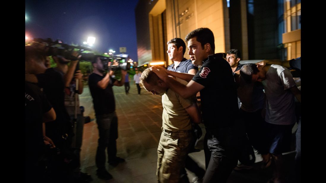 Police escort Turkish soldiers, accused of taking part in the attempted coup, as they leave a courthouse in Istanbul's Bakirkoy neighborhood on Saturday, July 16.