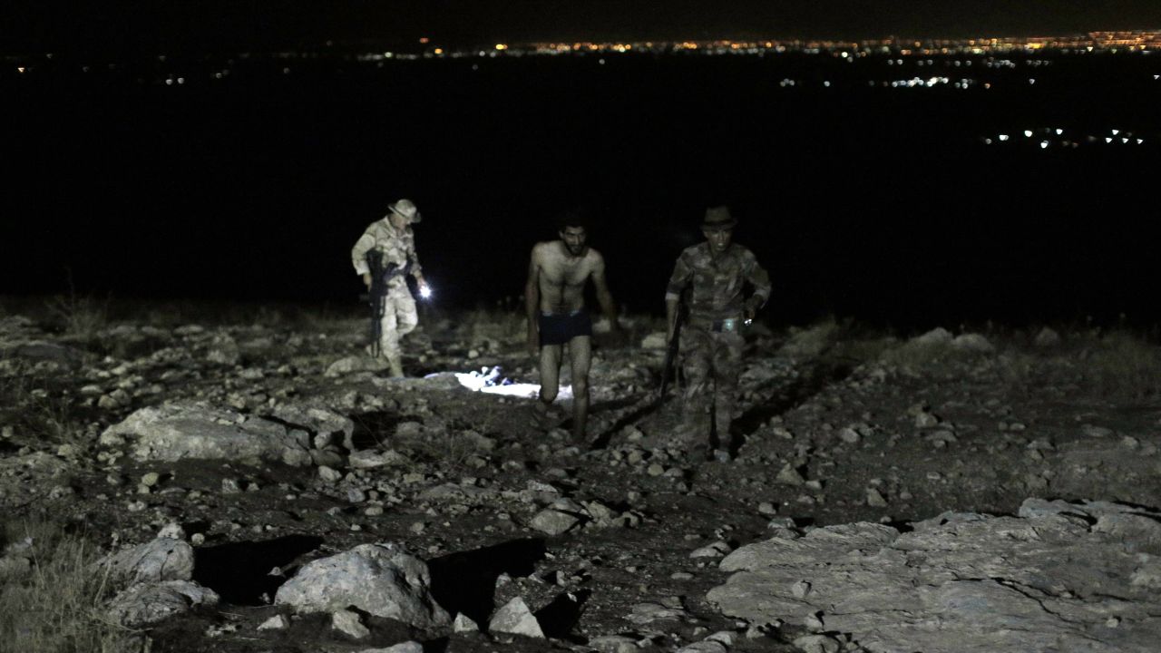 A man approaches soldiers after stripping down to his underwear.