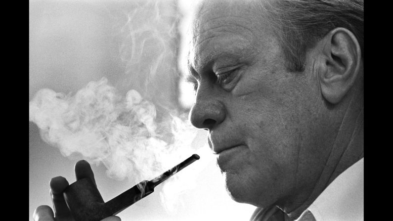 U.S. President Gerald R. Ford smokes his pipe as he heads to the 1976 Republican National Convention. Ford had more delegates at the time than his challenger, Ronald Reagan, but the race was close and both candidates would need to win over uncommitted delegates to secure the nomination.