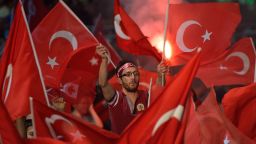 TOPSHOT - A man waves a Turkish flags during a meeting in support of the Turkish president on Taksim Square in Istanbul on July 19, 2016.
Turkey widened its massive post-coup purge to schools and the media on July 19, vowing to root out supporters of an exiled Islamic cleric it accuses of orchestrating the attempted power grab. / AFP PHOTO / DANIEL MIHAILESCUDANIEL MIHAILESCU/AFP/Getty Images