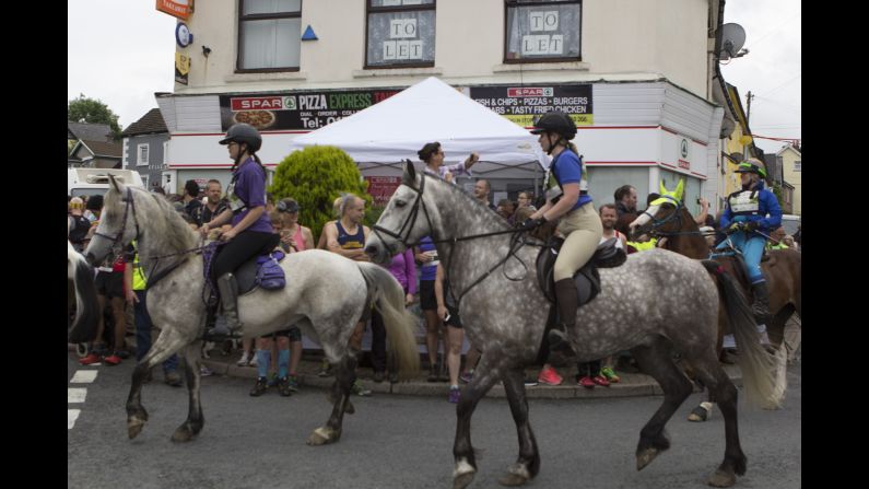 Horses convene up a side road and give the human racers a head start to avoid a Pamplona-style pell-mell at the starting line.<br />