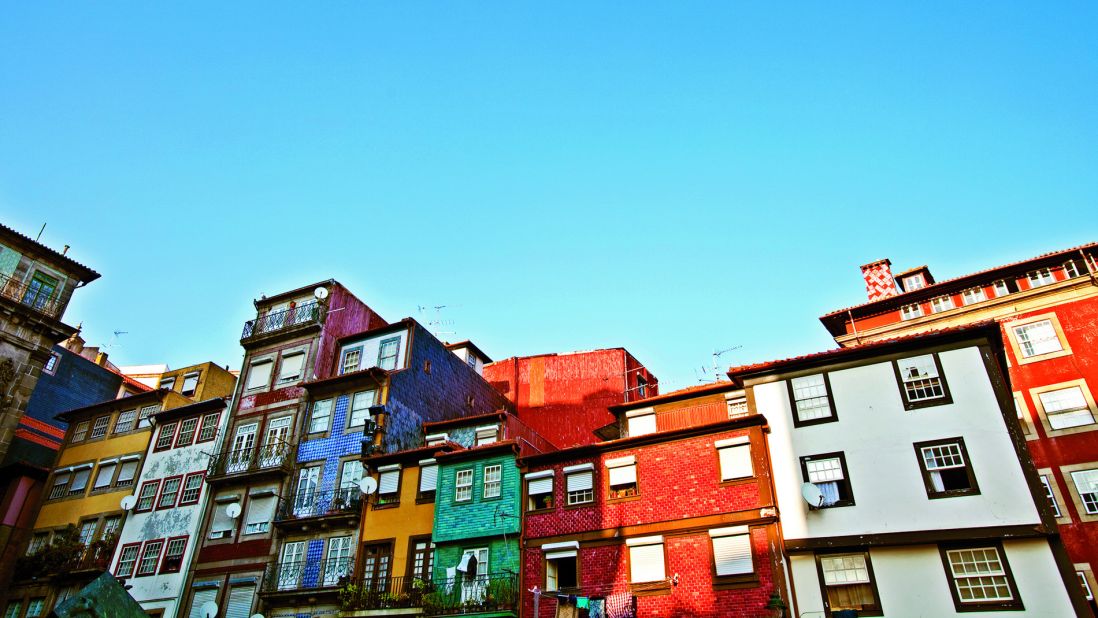 Ribeira Square, flanked by colorful painted houses, is a highlight in Porto's UNESCO-designated historical city center.