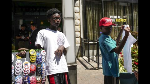 Young men sell Donald Trump merchandise and apparel on East 4th Street.