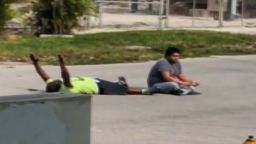 Charles Kinsey lies on the ground with his hands up. He was shot in the leg by North Miami police.