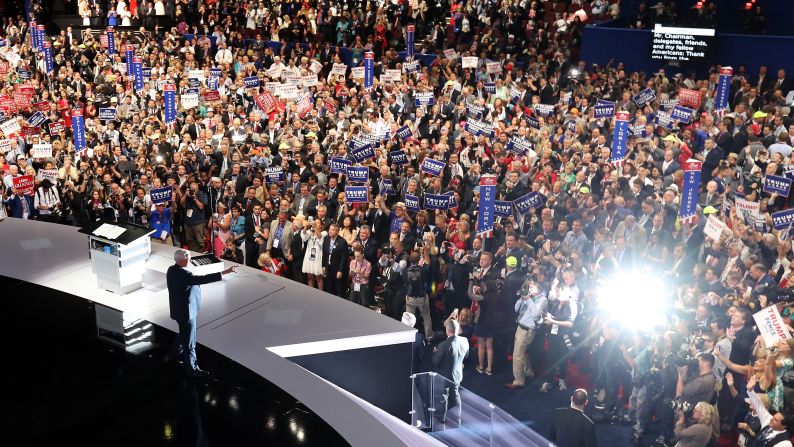 Pence acknowledges the crowd as he walks on stage to deliver his speech.