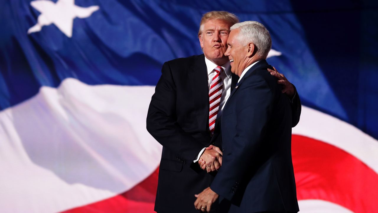 Republican presidential candidate Donald Trump stands with Republican vice presidential candidate Mike Pence on the third day of the Republican National Convention on July 20, 2016, at the Quicken Loans Arena in Cleveland, Ohio.