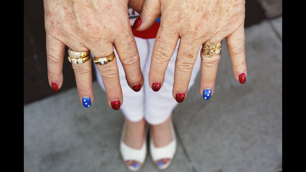 A woman displays her patriotic nails.