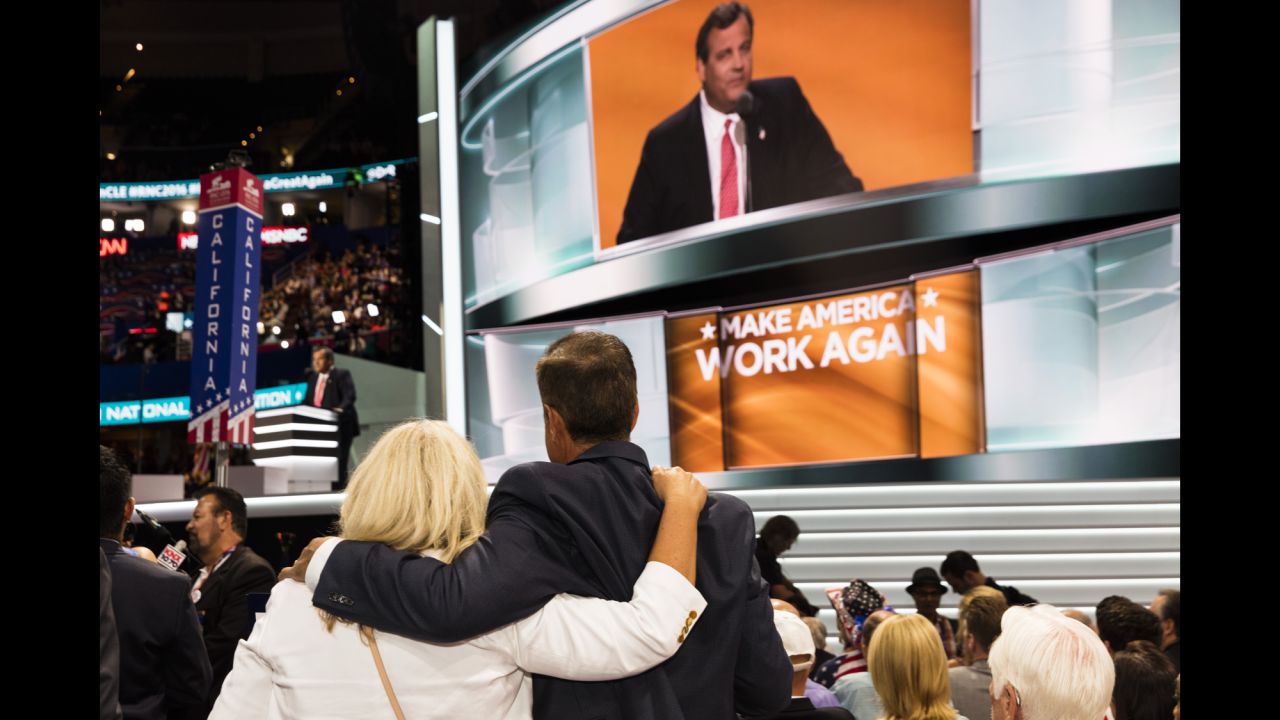 People watch New Jersey Gov. Chris Christie deliver a speech.