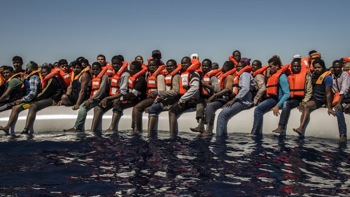 Migrants sit on a dinghy Tuesday, July 19, waiting to be rescued in the Mediterranean Sea near Libya. <a href="http://www.cnn.com/2015/09/03/world/gallery/europes-refugee-crisis/" target="_blank">Europe's migration crisis in 25 photos</a>