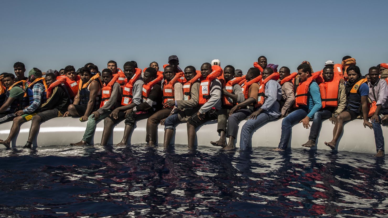 Refugees and migrants wait to be rescued from a dinghy in the Mediterranean Sea last year.