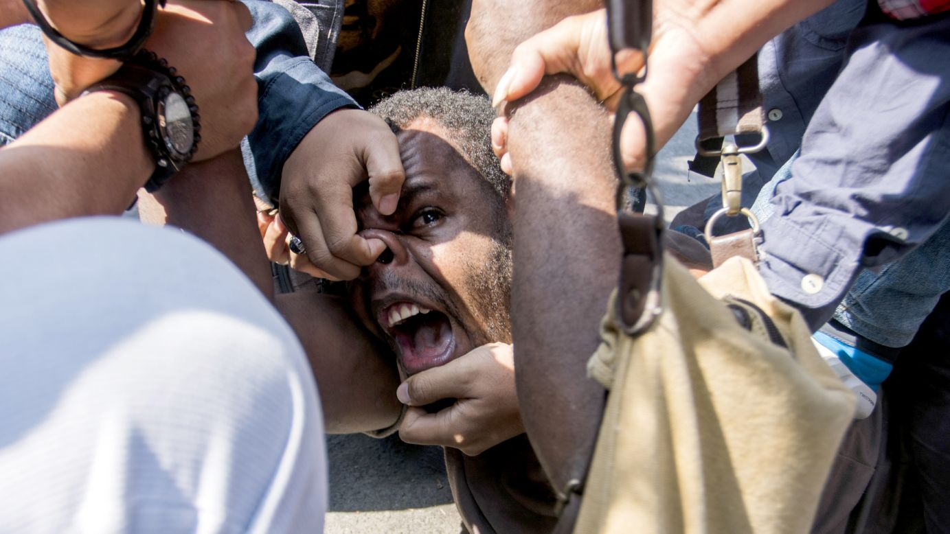 Papuan student Obi Kogoya screams as he is taken down by police while trying to join a protest in Yogyakarta, Indonesia, on Friday, July 15. Pro-independence sentiment runs high in Papua, which sits on the western end of the New Guinea island.