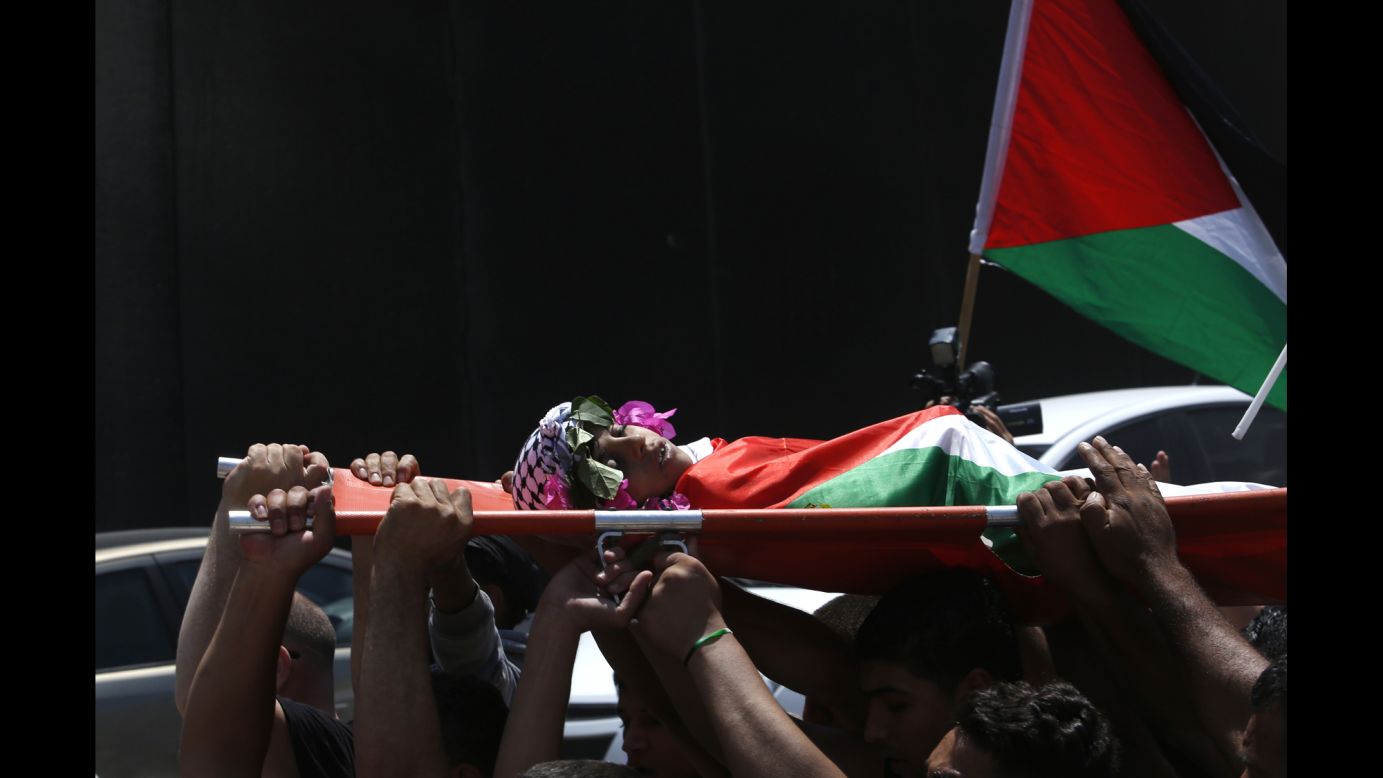 Mourners carry the body of Muhyi Sedqi al-Tabakhi during his funeral in the West Bank town of Al-Ram on Wednesday, July 20. The Palestinian Ministry of Health said the 12-year-old boy was shot and killed by Israeli forces in the West Bank. Israel police spokeswoman Luba Samri <a href="http://www.cnn.com/2016/07/19/middleeast/west-bank-palestinian-boy/index.html" target="_blank">disputed the claim</a> and said Israeli forces never opened fire.