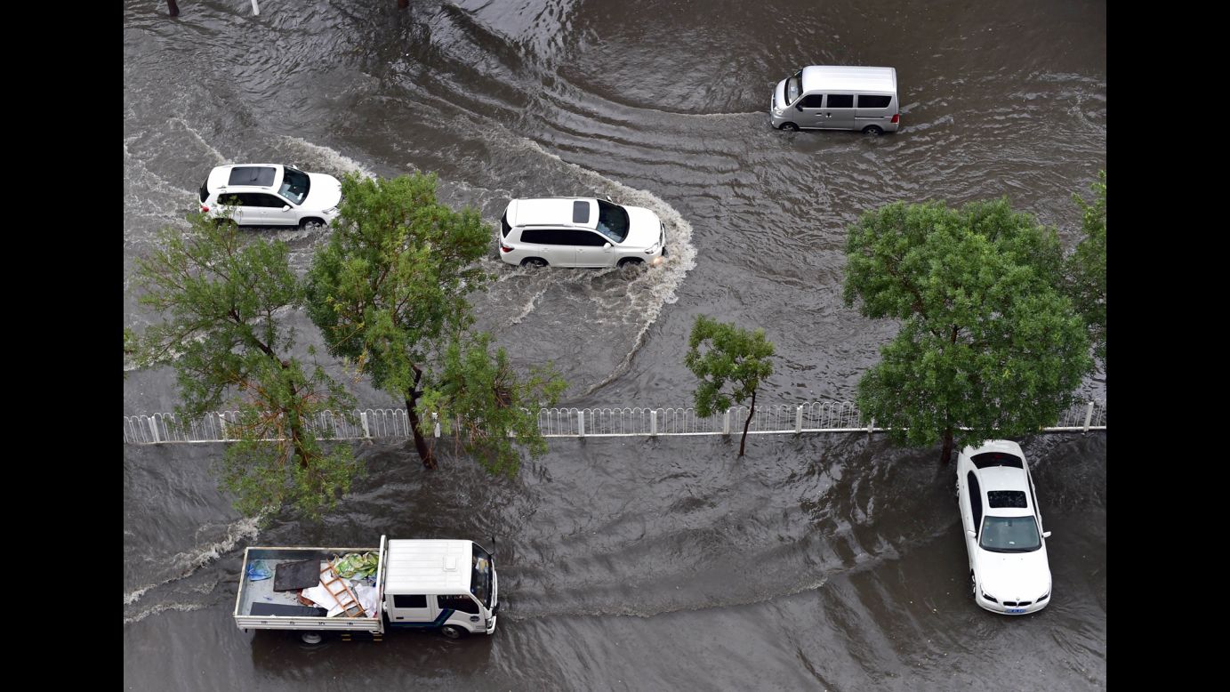 Vehicles drive on a flooded road in Tianjin, China, on Wednesday, July 20.