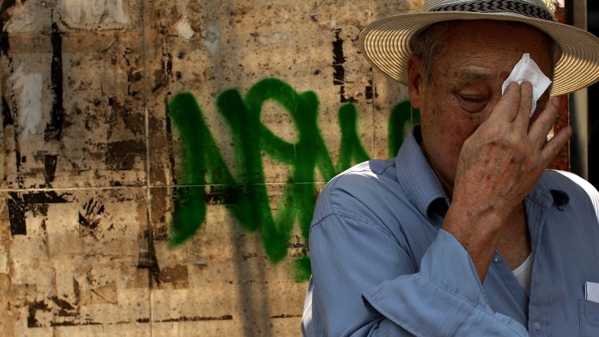 NEW YORK - JULY 10: A man wipes sweat from his face July 10, 2007 in New York City. New York City is experiencing a second day of a heat wave with temperatures in the upper 90`s and uncomfortable humidity levels. (Photo by Spencer Platt/Getty Images)
