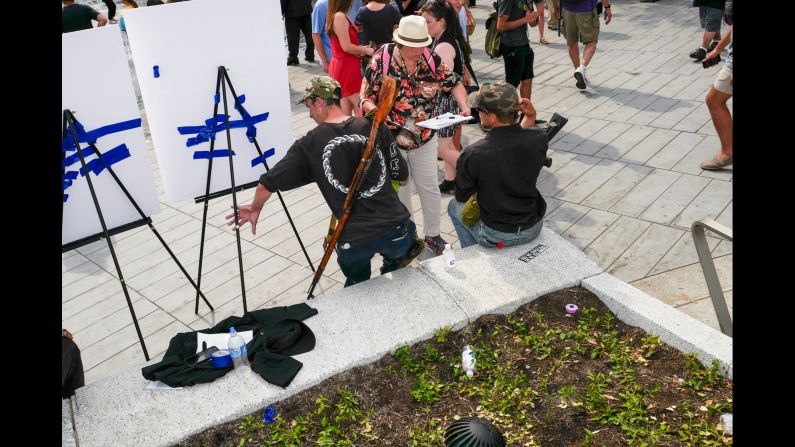 Two men hold firearms in Cleveland's Public Square. "I've seen open carry before but not quite in these numbers," van Agtmael said.