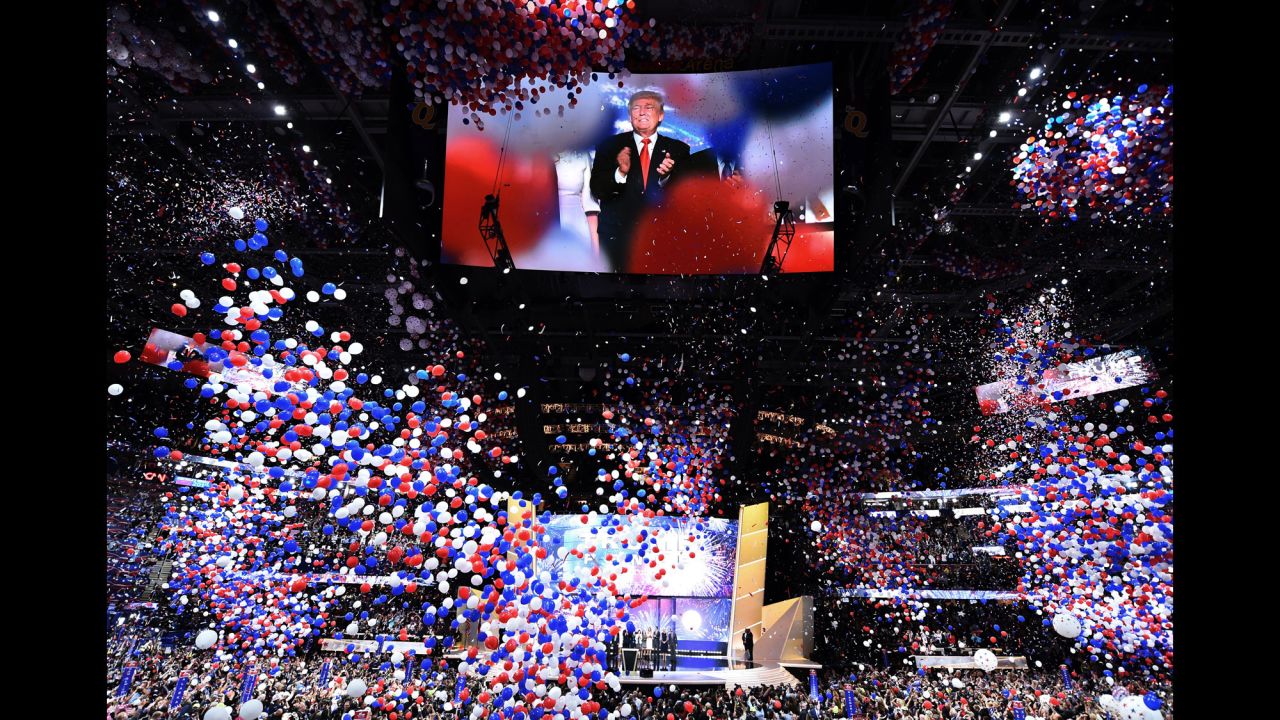 Trump is seen on screen as balloons fall from the ceiling of Quicken Loans Arena.
