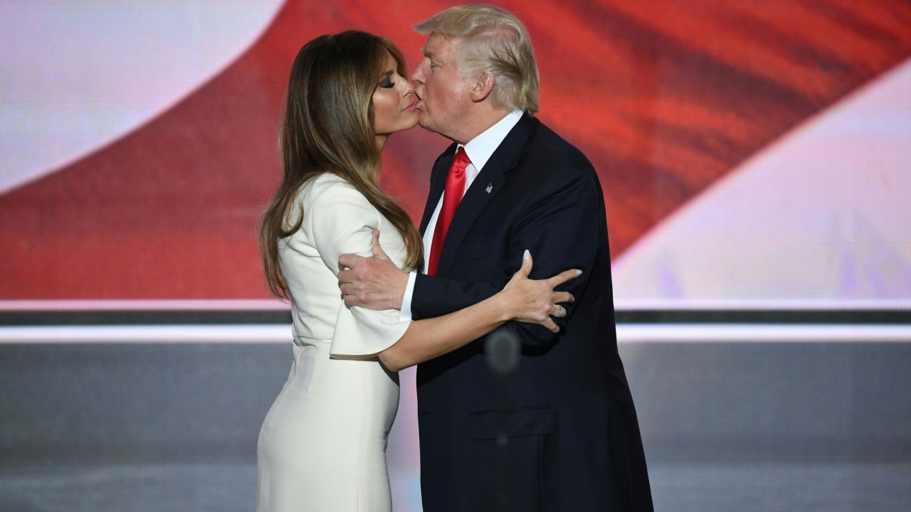 The Trumps embrace on stage.