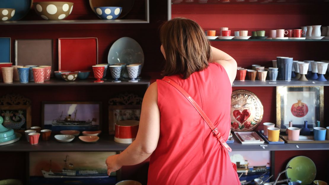 Betul, a human resource manager and  mother of two boys, poses for a photo in a shop, in Istanbul.