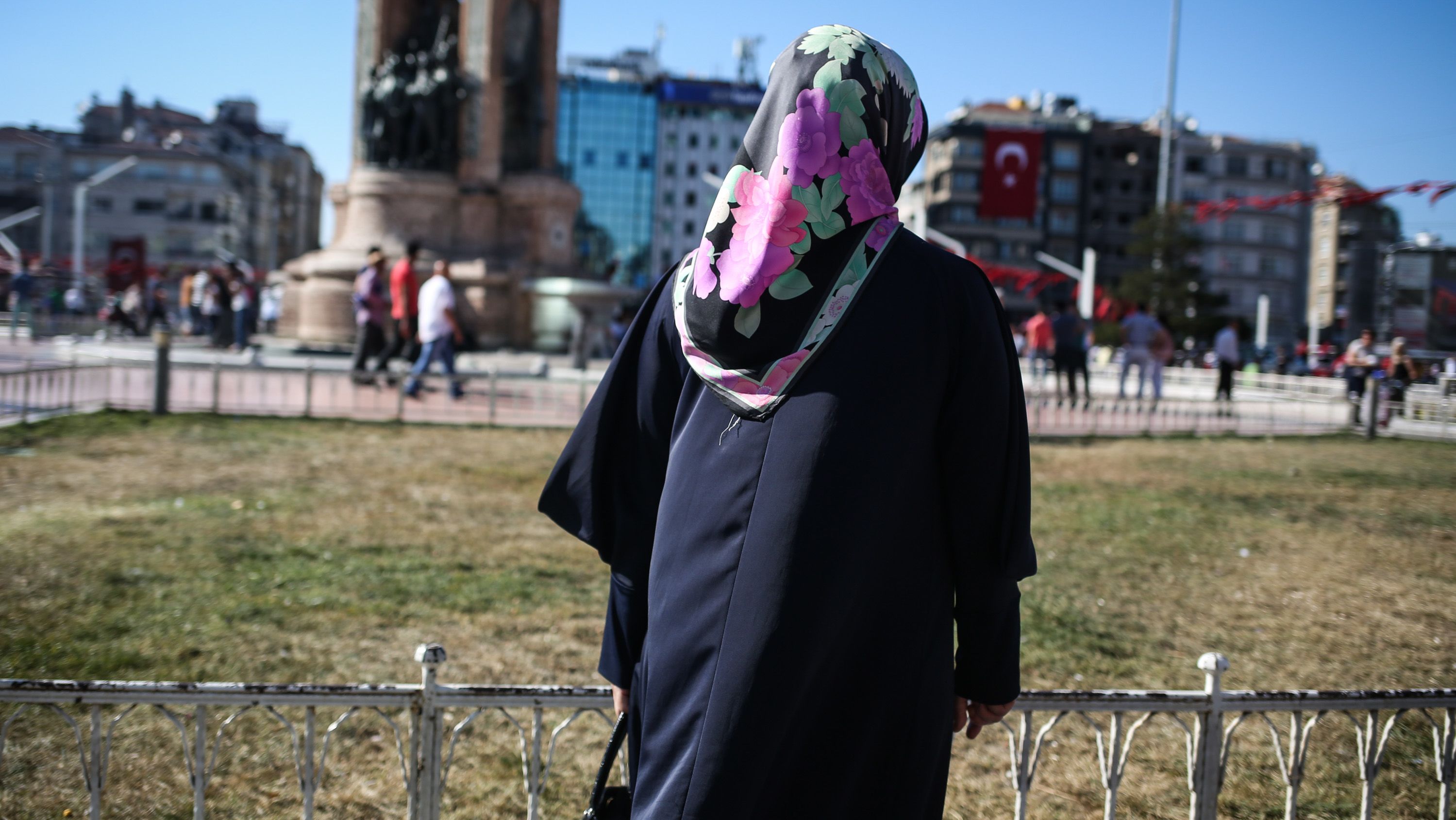 Serap, a housewife, poses for a photo in Taksim Square, in Istanbul.