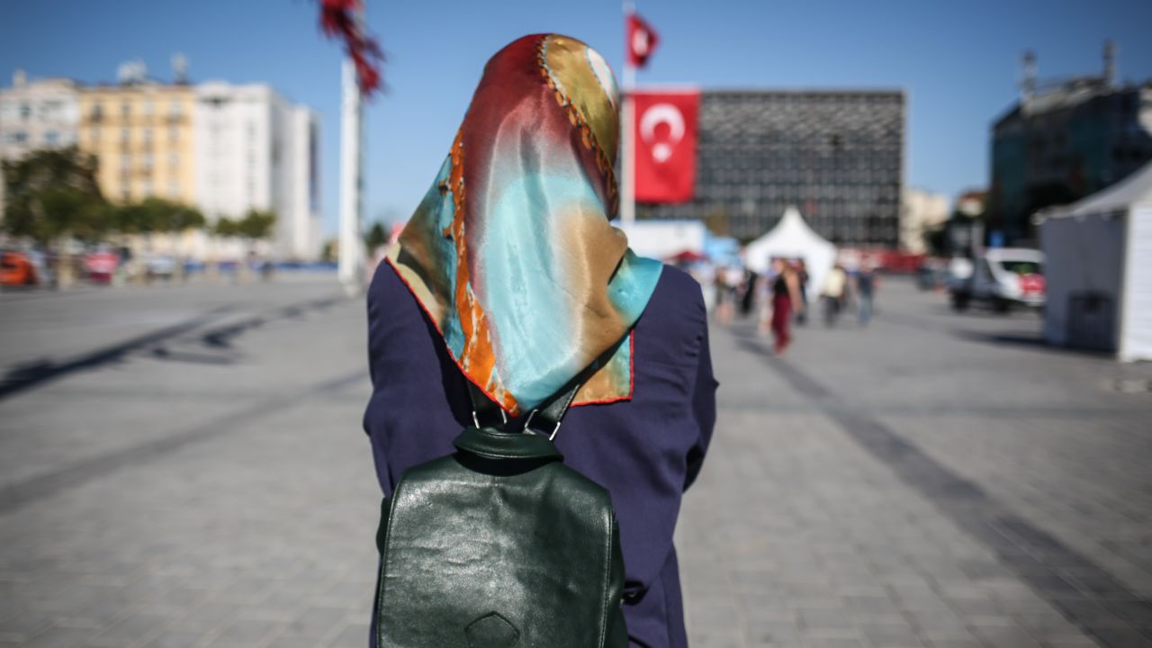 Nurgul, a Kurdish waitress, poses for a photo in Taksim Square, in Istanbul.