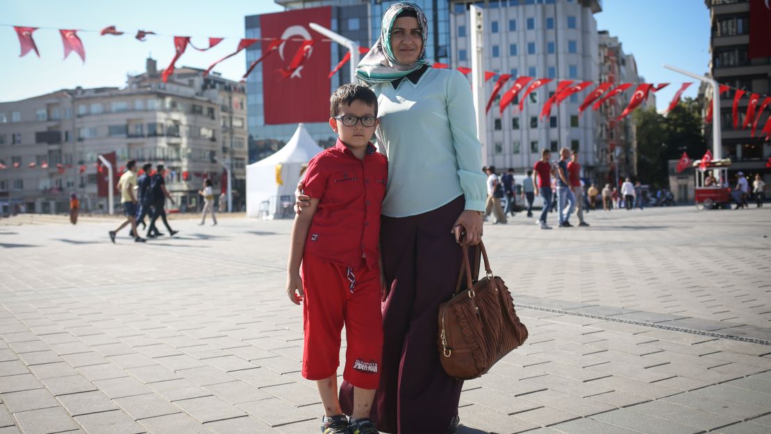 Nurdan, a housewife and mother, poses for a photo with her son, in Taksim Square, in Istanbul.