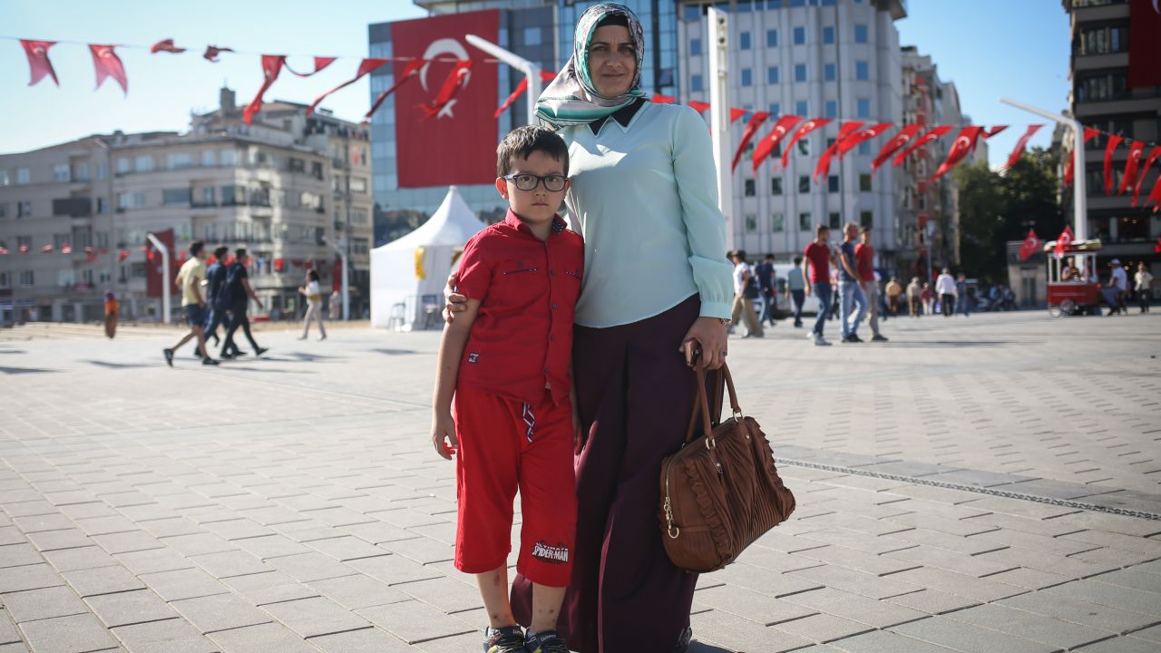 Nurdan, a housewife and mother, poses for a photo with her son, in Taksim Square, in Istanbul.