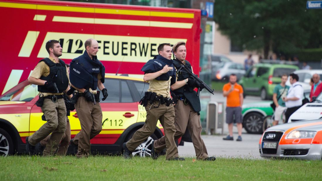 Police walk near the scene of the shooting.