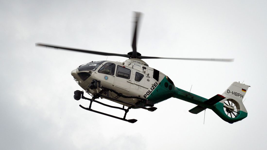 A police helicopter flies over the mall.