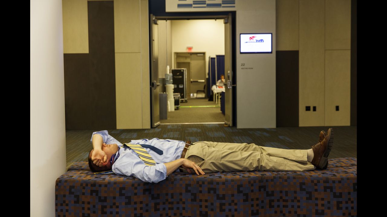 A man rests at a nearby convention center where many media members were working.