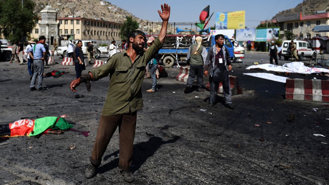 An Afghan protester screams near the scene of the suicide attack.