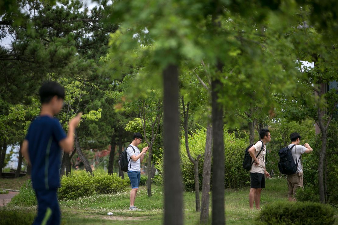 South Koreans youths play Pokemon Go on July 15 in Sokcho, South Korea. 