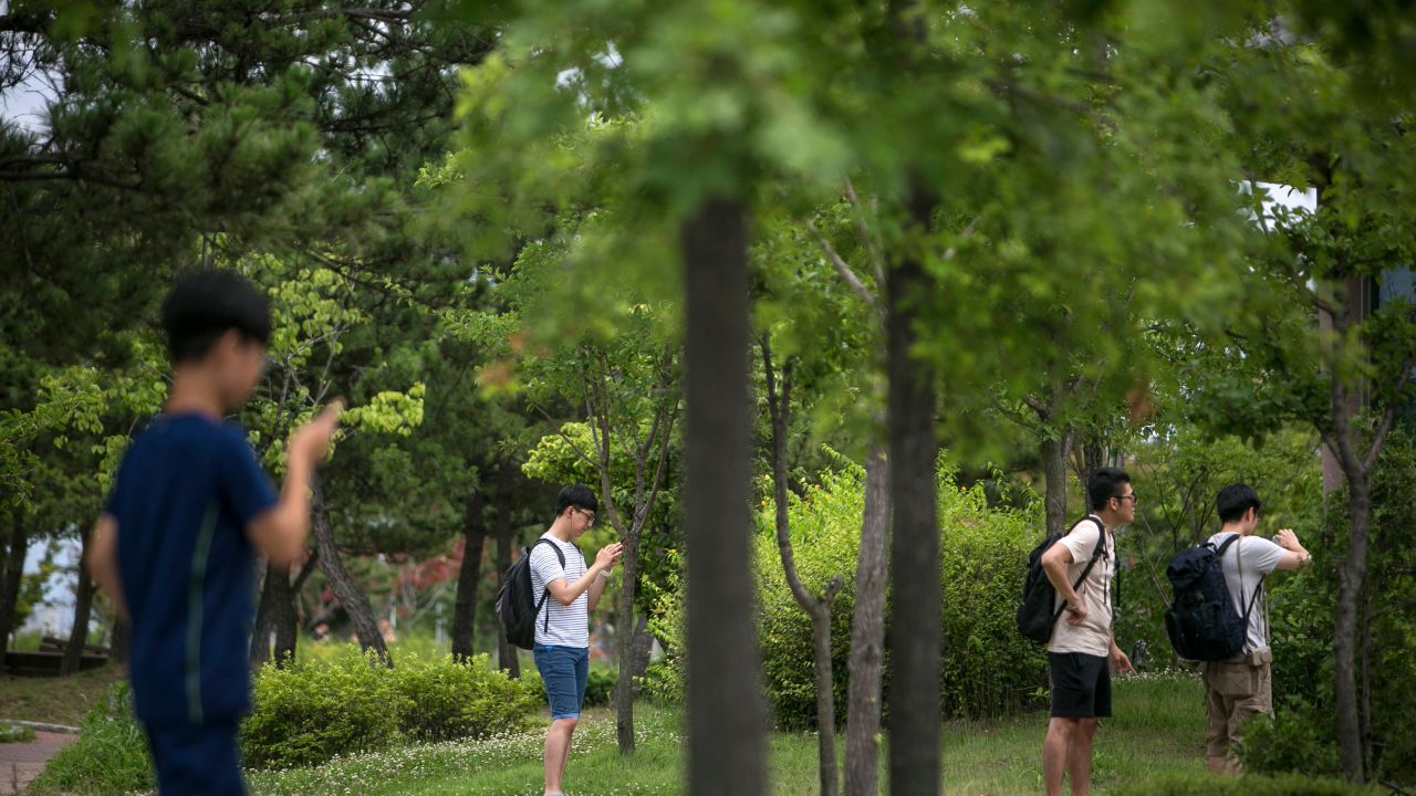 South Koreans youths play Pokemon Go on July 15 in Sokcho, South Korea.