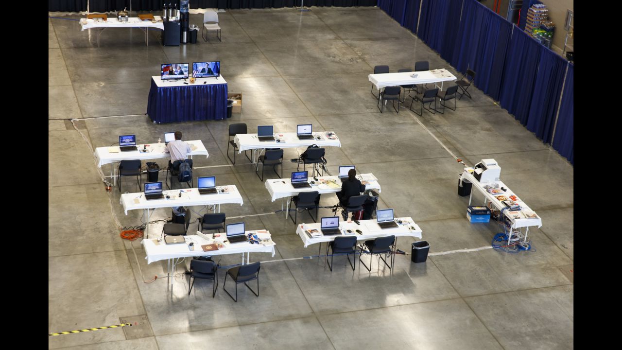 Members of the media work at a nearby convention center.