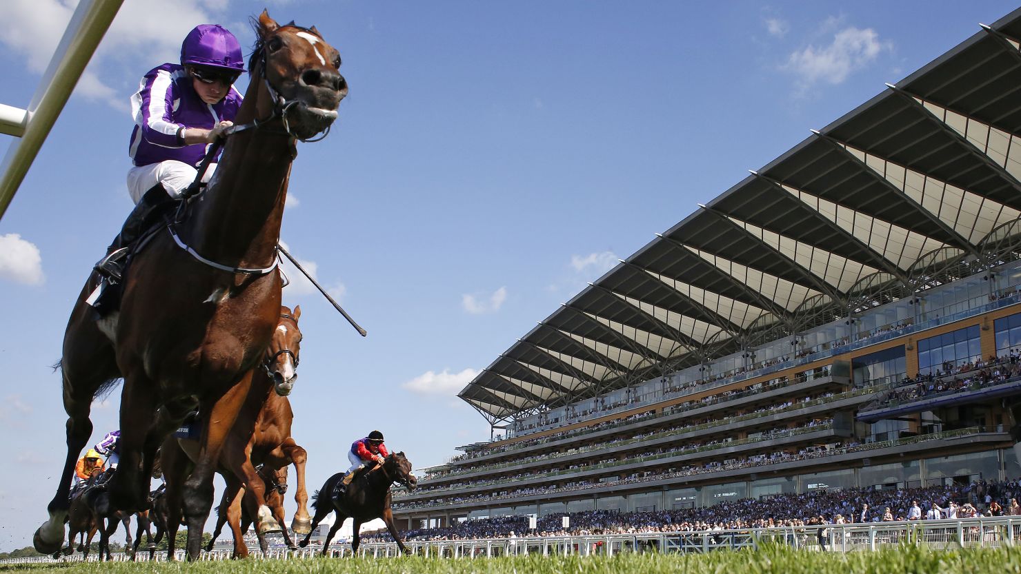 Ryan Moore riding Highland Reel races towards the line in The King George VI And Queen Elizabeth Stakes at Ascot Racecourse.