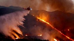 An Los Angeles County Fire Department Air Ops Chopper drops water over the Sand Fire.