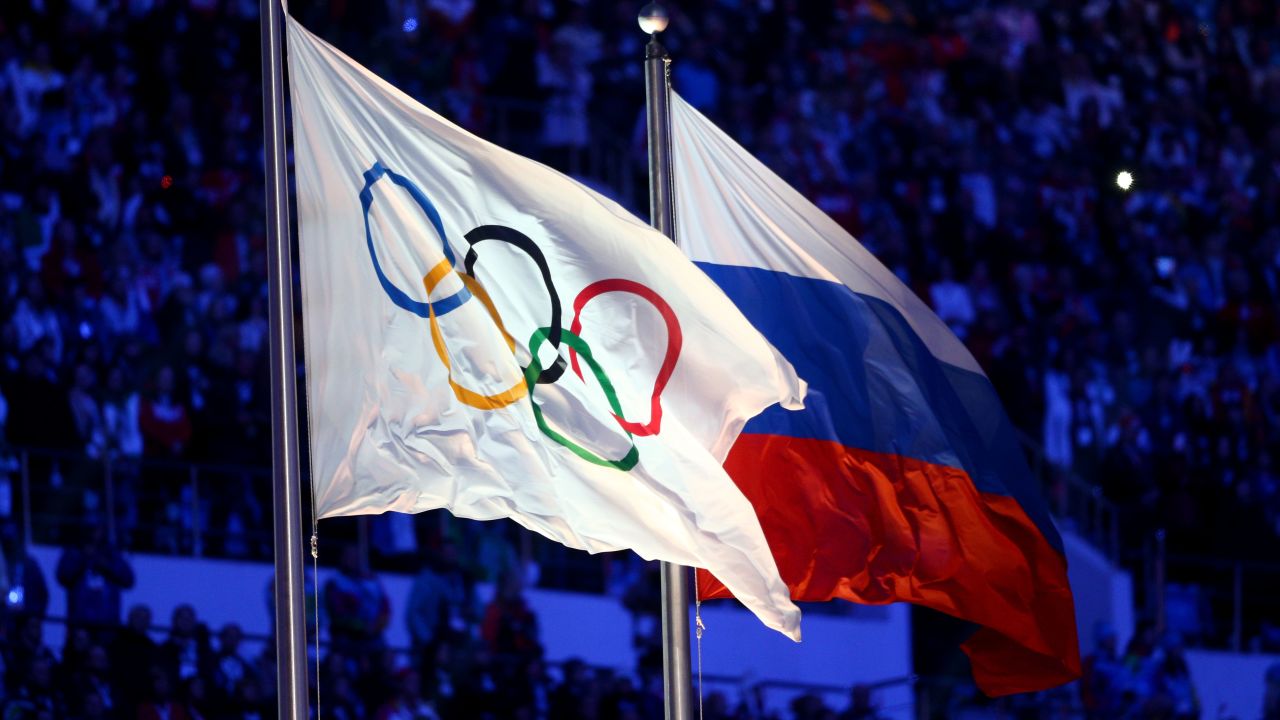 The Olympic flag and Russian flag are raised as the Russian National Anthem is sung during the 2014 Sochi Winter Olympics Closing Ceremony.