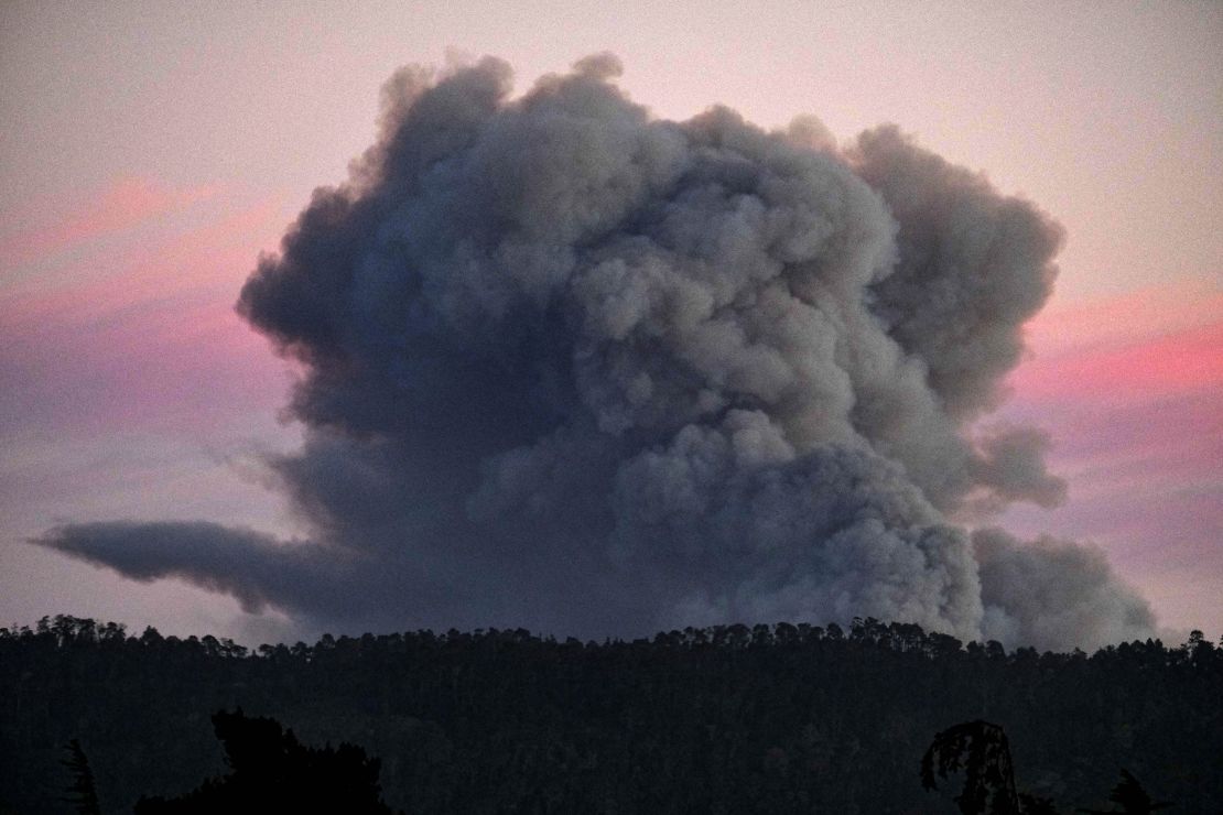 A large plume of smoke from a fire rises Friday south of Carmel, California.