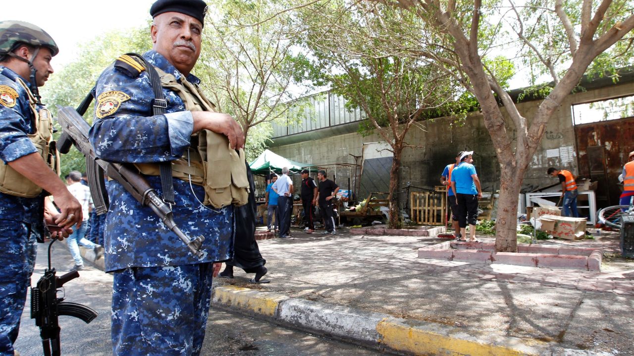 Iraqi security forces stand guard at the site of Sunday's blast.