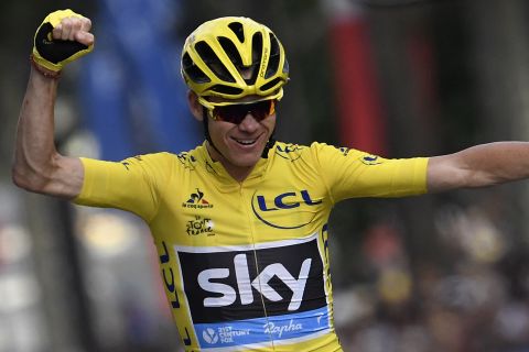 Chris Froome of Team Sky celebrates as he crosses the finish line to win the 103rd edition of the Tour de France cycling race Sunday.