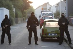 Police officers secure a street near where the bomber lived.