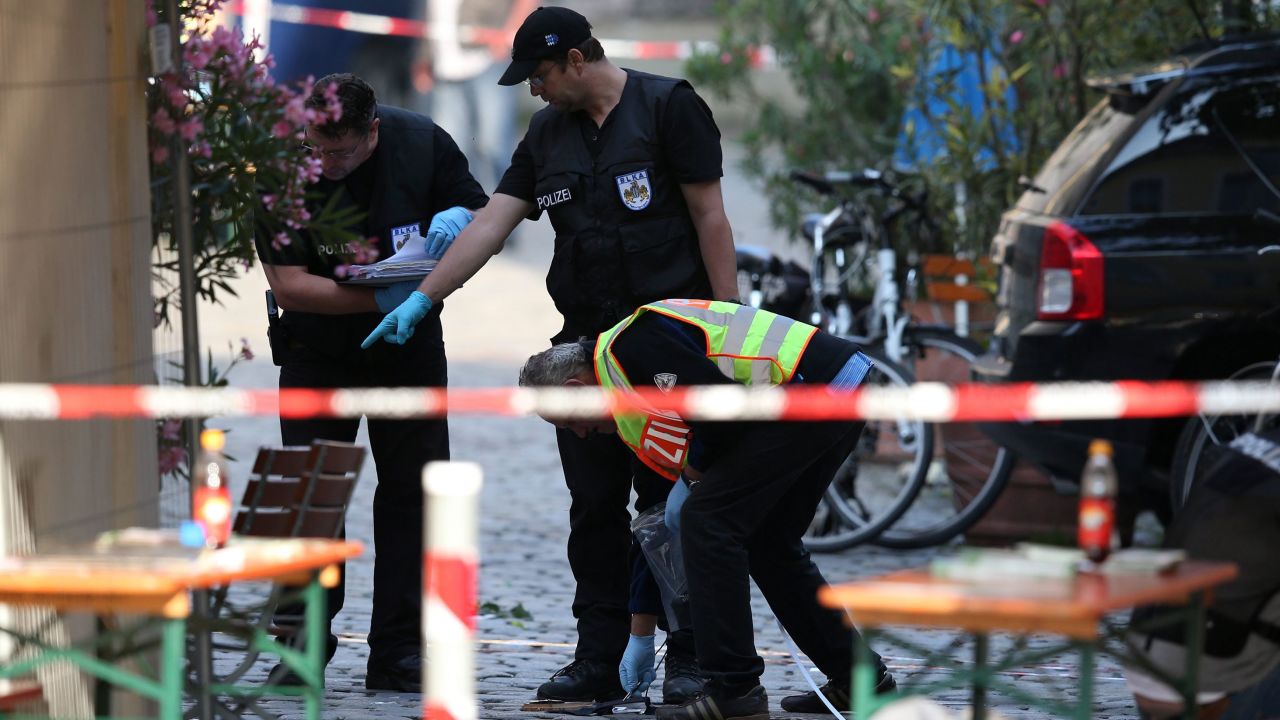 Police officers conduct an investigation on Monday, following a suicide bombing in Ansbach, Germany.