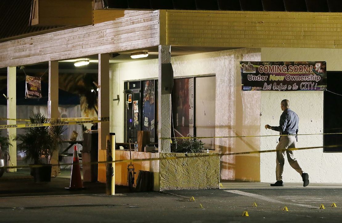 An investigator walks near the scene of Monday's shooting in Fort Myers.