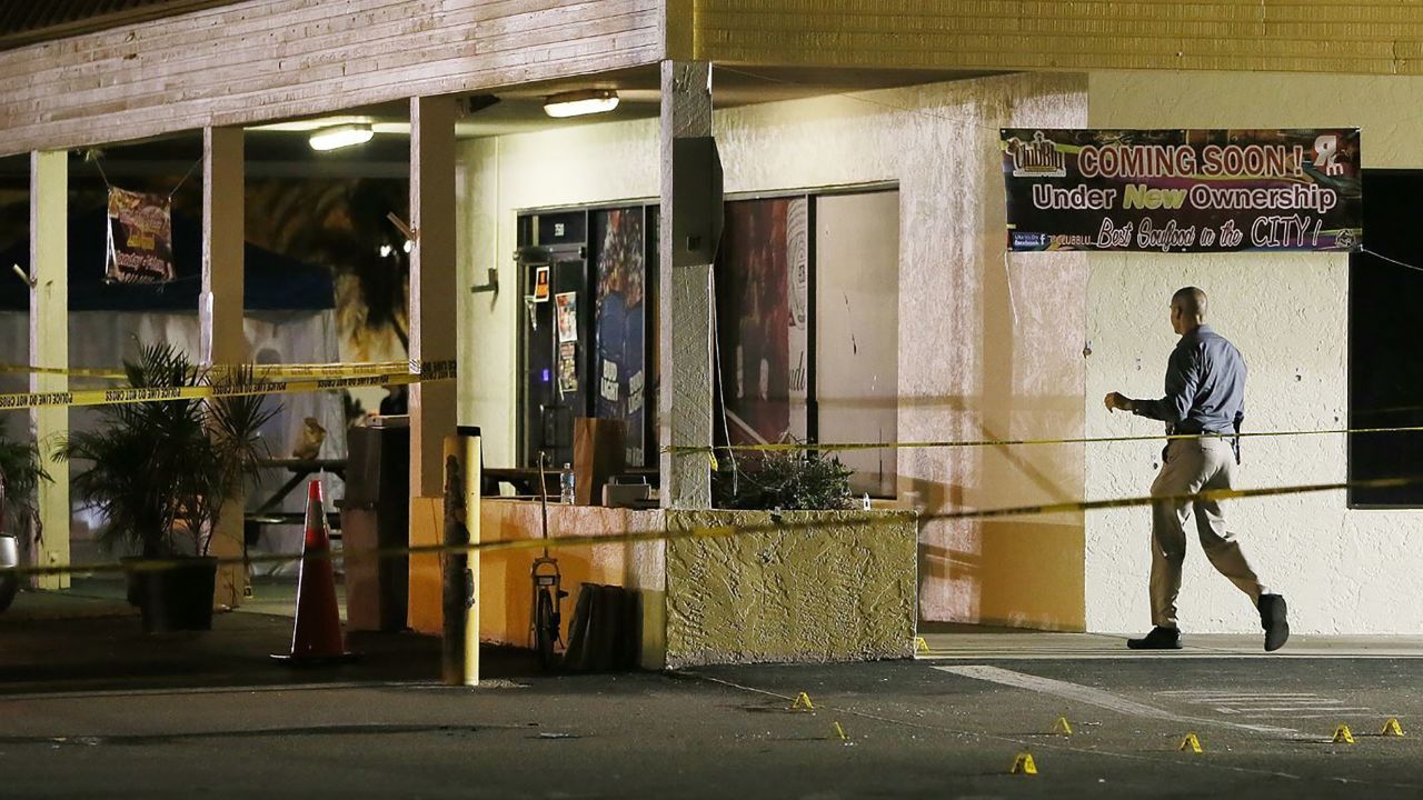 An investigator walks near the scene of Monday's shooting in Fort Myers.
