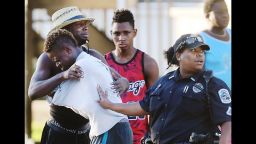 People embrace after a fatal shooting at Club Blu in Fort Myers, Fla., Monday, July 25, 2016. (Kinfay Moroti/The News-Press via AP)