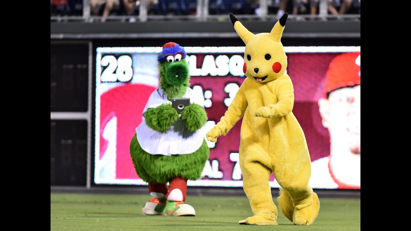 Even the Phillie Phanatic has <a href="http://www.cnn.com/2016/07/11/health/pokemon-go-guide-trnd/index.html" target="_blank">Pokemon fever.</a> The iconic mascot, left, tries to capture Pikachu during a Philadelphia Phillies game on Tuesday, July 19.