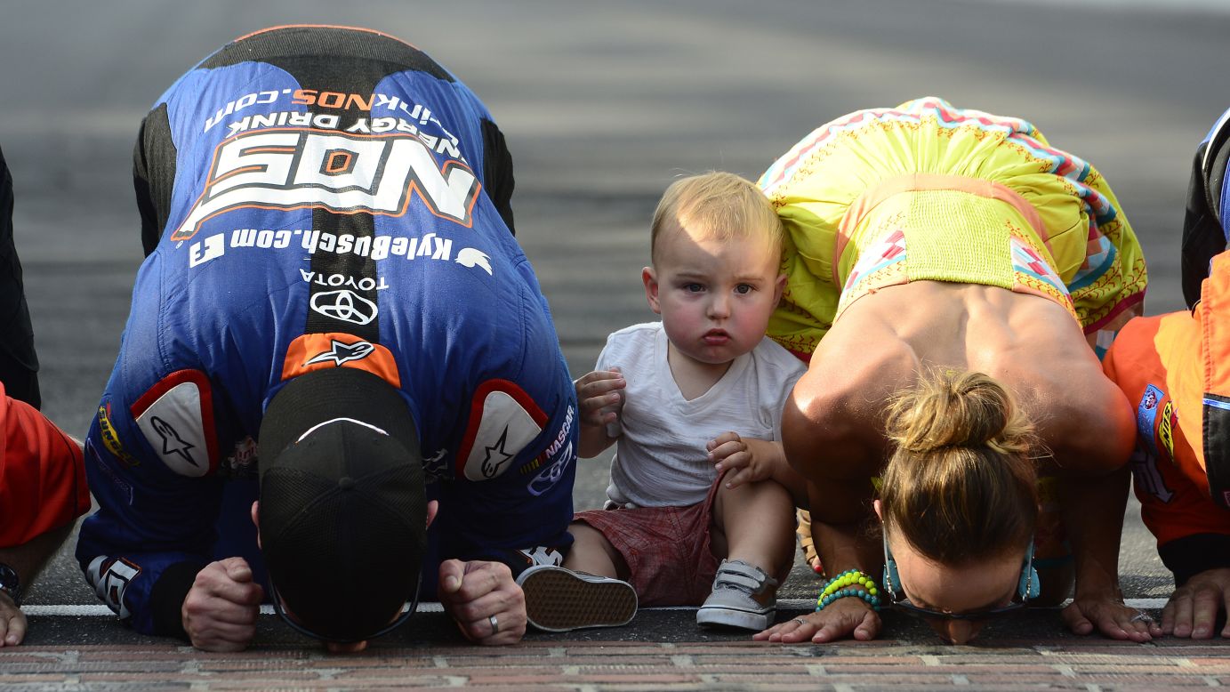 NASCAR driver Kyle Busch -- joined by his wife, Samantha, and their son, Brexton -- kisses the bricks at Indianapolis Motor Speedway on Saturday, July 23. Busch had just won the Xfinity Series race there. He won the Sprint Cup race the next day for a weekend sweep.