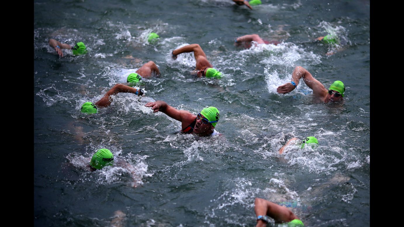 Triathletes swim during the Ironman race in Zurich, Switzerland, on Tuesday, July 19.