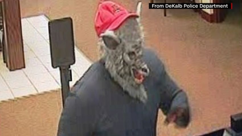 Bank robber in wolf mask has news anchors howling. CNN's Jeanne Moos reports on anchors in stitches.    Wolf Robber Giggles   A story about a bank robber in a wolf mask sent a pair of Chicago TV anchors into a live fit of the giggles. Maybe it was the baseball hat on top of the wolf mask that did it. The male anchor, Ben Bradley, blamed his co-anchor saying ?It?s Stacey?s fault?  and he was right.  Stacey Baca could barely speak. There?s a technical term for when this happens??church giggles? is what Kathy Griffin calls it.  We?ll toss in a few other examples of out of control anchors and will update the latest info on the hunt for the wolf mask bank robber while we?re at it. The wolf was also wearing a red hat which fell off. Cops are now testing the hat for DNA.