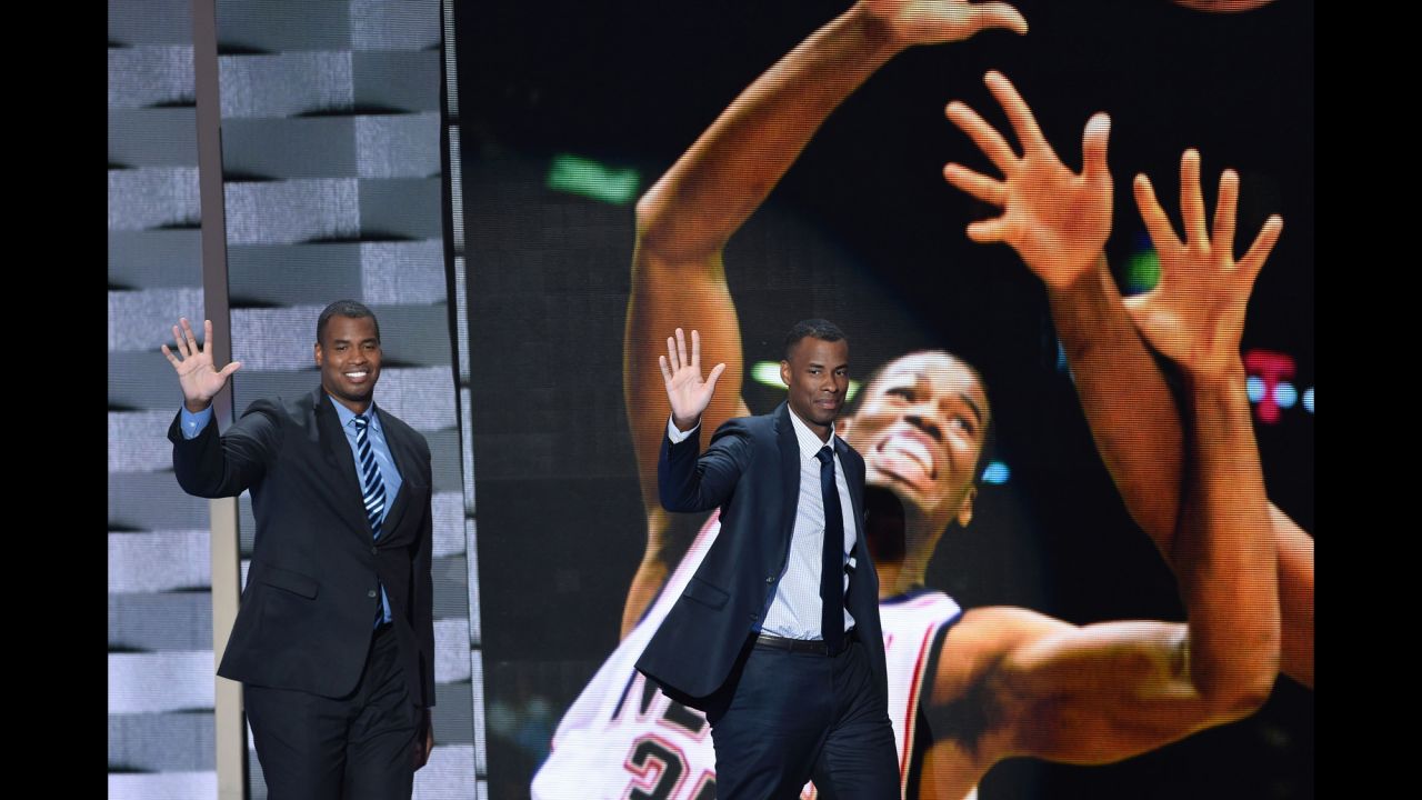 Former pro basketball players Jason Collins, left, and Jarron Collins wave to the crowd. Jason Collins, the first openly gay player in the NBA, said he told the Clintons about his sexual orientation before coming out publicly.