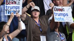 A Bernie Sanders supporter gestures during Day 1 of the Democratic National Convention at the Wells Fargo Center in Philadelphia, Pennsylvania, July 25, 2016. / AFP / Robyn BECK        (Photo credit should read ROBYN BECK/AFP/Getty Images)